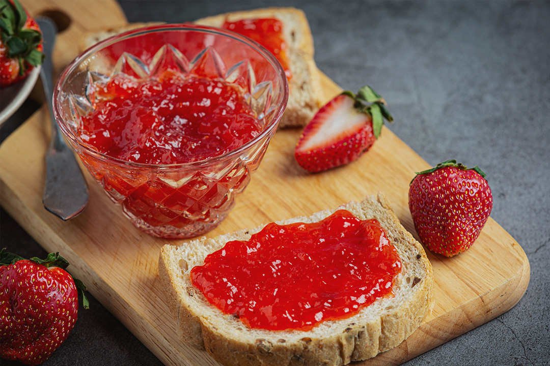 toasts-with-strawberry-jam-on-old-dark-background
